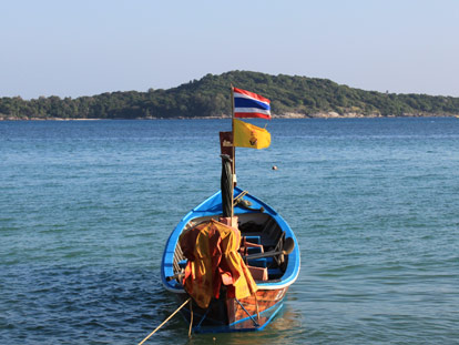 Thai longboat with flags