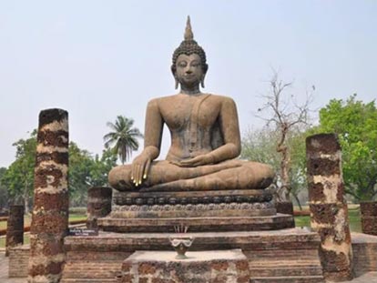 Stone Buddha statue sitting with legs crossed