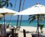 Beachfront cafe on Koh Samui with speedboat in background