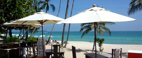 Beachfront cafe on Koh Samui with speedboat in background